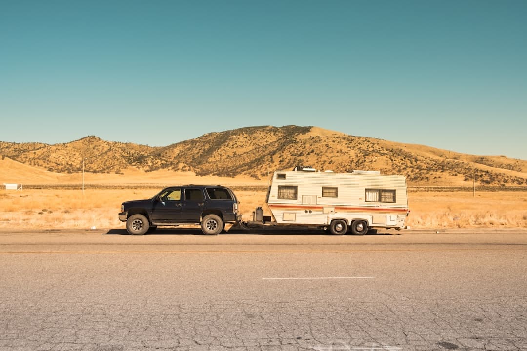 A four-wheel drive towing a caravan on an open road — toy hauler caravan guide